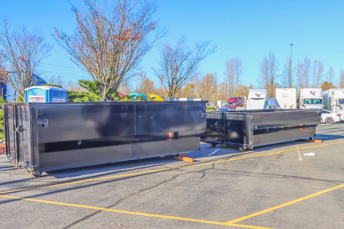 Professional dumpster rental service with roll-off container on residential driveway in New Orleans